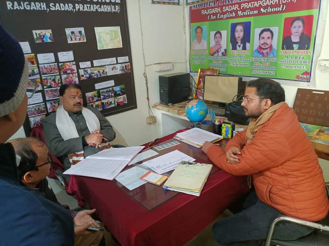 Participants meeting around a desk in a school office